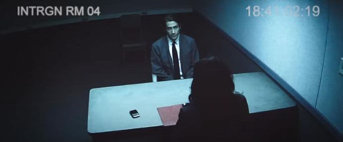 jake gyllenhaal's character sits in an interrogation room