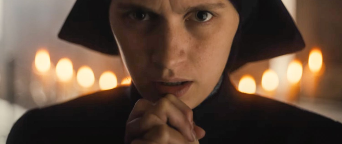 a nun with her hands clasped in prayer