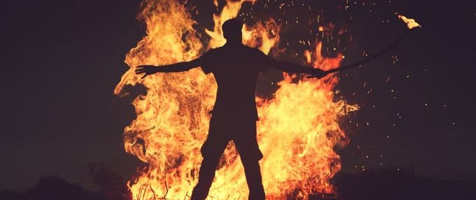 The silhouette of a man surrounded by flames.